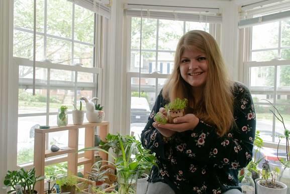 Maggie Deely portrait, holding plant