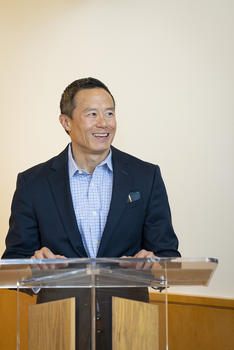 Jeff Shen stands at a podium during the Professional Development Ruondtablee